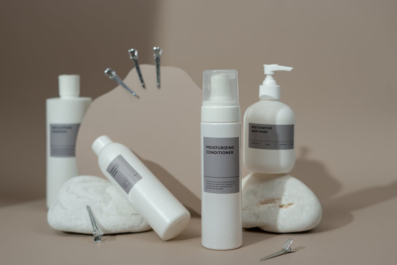 Elegant still life of beauty products and hair accessories on a neutral background, highlighting a minimalist design.